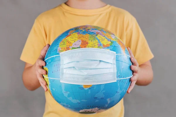 Coronavirus Kid Holding Earth Globe Medical Face Mask Gray Background — Stock Photo, Image