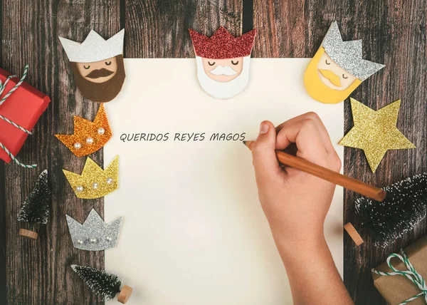 stock image Child hands writing letter to the three kings of orient over wooden background.Christmas concept background.