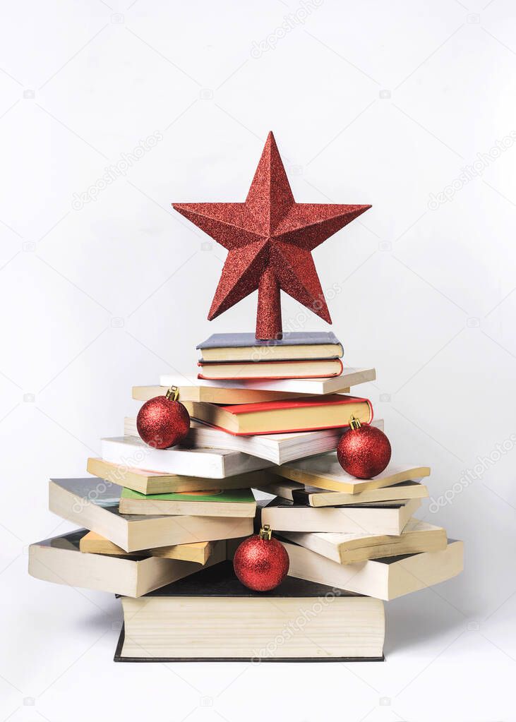 Christmas concept background. Books in the form of a christmas tree on white background