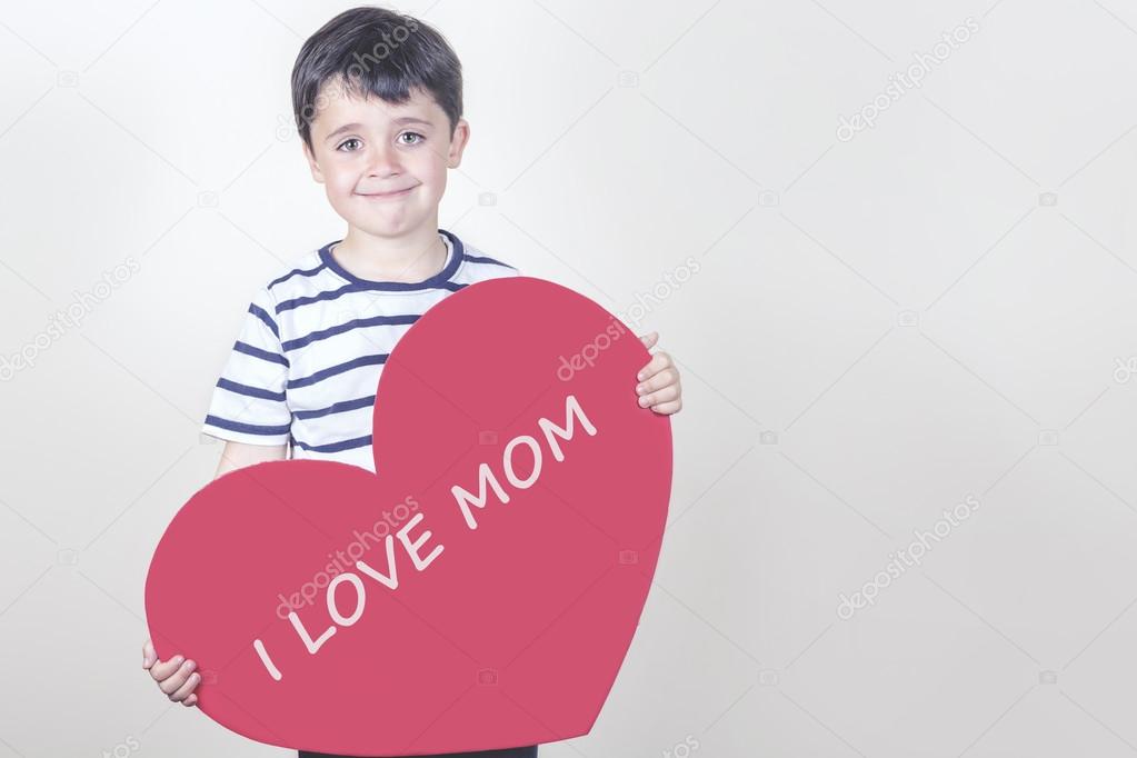 smiling boy with a red heart for the Mother's Day