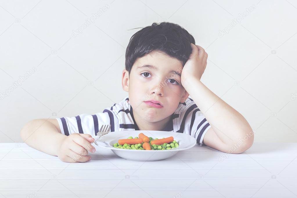 Sad child with a meal