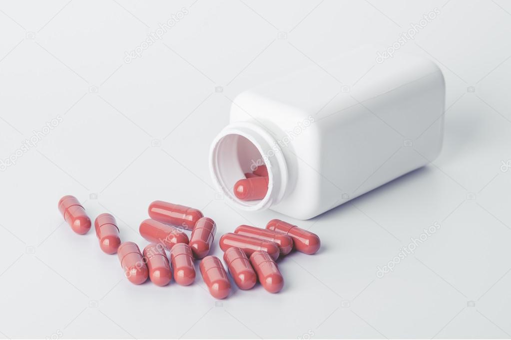 jar of pills on white background
