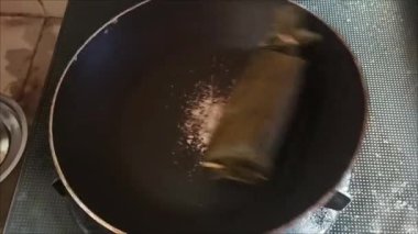 Yapışkan olmayan bir tavada Lemper pişirildi. Yapışkan pirinç ve muz yapraklarına sarılmış baharatlı tavuktan yapılan geleneksel bir Endonezya atıştırmalığı..