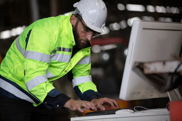 construction worker using laptop, Engineer standing with confident against machine environment in factory