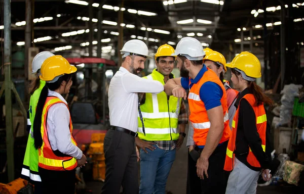 Group of Engineer manager and Factory Workers Team standing against production line.,Male Industrial Engineers Talk with Factory Worker . They Work at the Heavy Industry Manufacturing Facility.