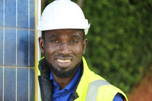 Engineer working on checking and maintenance equipment at solar panels power farm, photovoltaic cell park, green energy concept.