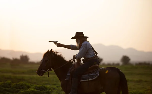 牛仔骑着马面对美丽的日落 牛仔和马在黎明时分 河流和生活方式与自然光背景 — 图库照片
