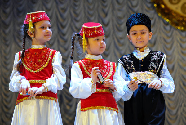 Crimean tatar children in native dresses singing native song on stage. Concert Winter tale. December 24, 2017. Kyiv, Ukraine