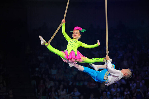 Children-aerialists performing under dome of circus. June 10, 2018. Kiev, Ukraine
