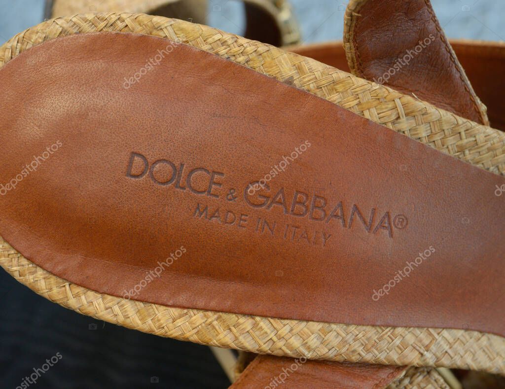 Brand name Dolce Gabbana on an insole of women sandals made of natural leather and straw. November 1, 2025. Kyiv, Ukraine