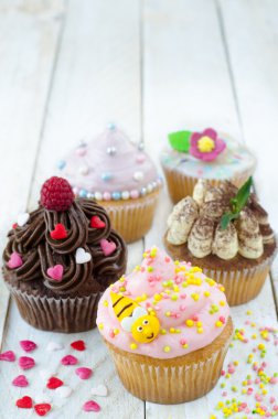 Beyaz ahşap zemin üzerinde çeşitli Cupcales