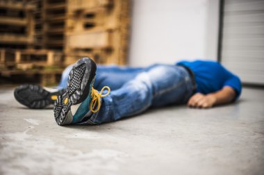 unconscious man after fatal work injury clipart