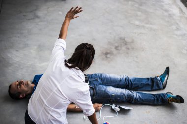 Defibrilatör ve Cpr bilinçsiz bir adamla yardımcı kız