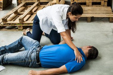 girl assisting an unconscious guy clipart