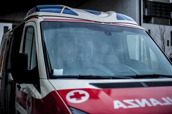 Emergency volunteer operators with medical devices, stretcher and ambulance — Stock Photo, Image