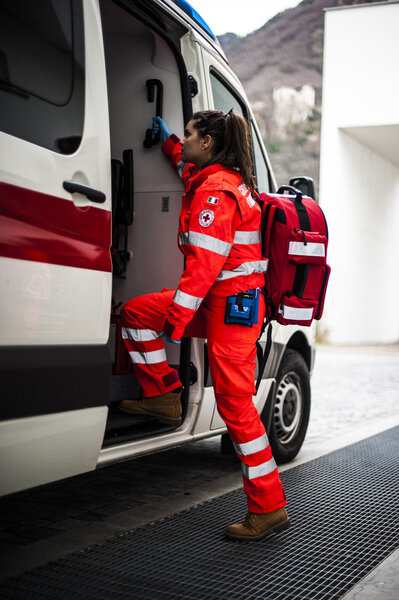 emergency volunteer operators with medical devices, stretcher and ambulance