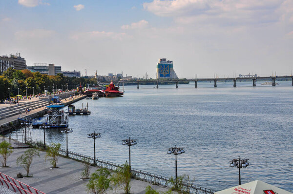 Panoramic View of Dnipro River in Dnipro City, Ukraine: Cityscape with Central Bridge and Modern Skyline Architecture on a Sunny Day