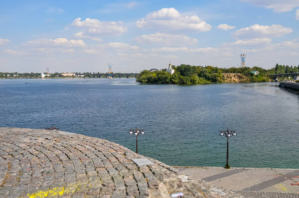 Panoramic View of Dnipro River in Dnipro City, Ukraine: Cityscape with Central Bridge and Modern Skyline Architecture on a Sunny Day