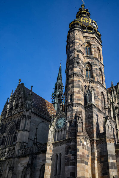 Exterior View of St. Elisabeth Cathedral in Kosice, Slovakia: Gothic Architecture Landmark with Ornate Tower, Golden Clock and Historical Old Town Cathedral