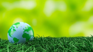 Yeşil ve mavi dünya küresi taze çimenlerin üzerinde dinleniyor. Çevre korumasını, sürdürülebilirliği, iklim farkındalığını ve daha temiz bir geleceğin küresel sorumluluğunu sembolize ediyor.