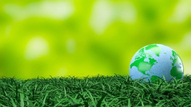 Yeşil ve mavi dünya küresi taze çimenlerin üzerinde dinleniyor. Çevre korumasını, sürdürülebilirliği, iklim farkındalığını ve daha temiz bir geleceğin küresel sorumluluğunu sembolize ediyor.