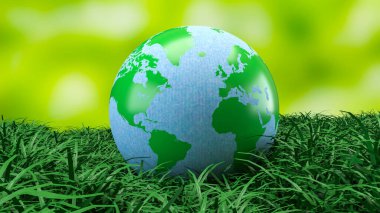 Yeşil ve mavi dünya küresi taze çimenlerin üzerinde dinleniyor. Çevre korumasını, sürdürülebilirliği, iklim farkındalığını ve daha temiz bir geleceğin küresel sorumluluğunu sembolize ediyor.