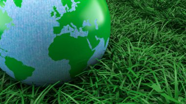 Yeşil ve mavi dünya küresi taze çimenlerin üzerinde dinleniyor. Çevre korumasını, sürdürülebilirliği, iklim farkındalığını ve daha temiz bir geleceğin küresel sorumluluğunu sembolize ediyor.