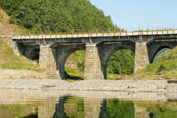 The bridge from a stone on the railroad — Stock Photo, Image