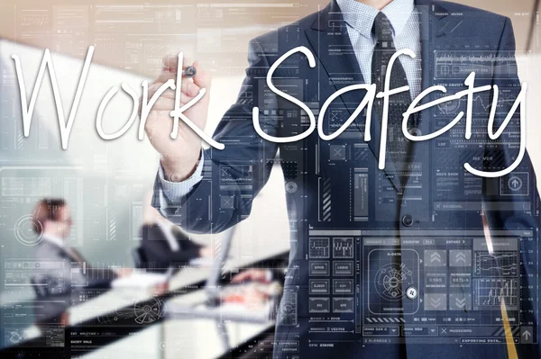 Businessman is writing on transparent board, he is preparing for presentation about : Work Safety — Stock Photo, Image