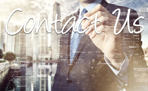 Businessman writing Contact Us on virtual screen behind the back