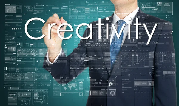 The businessman is writing Creativity on the transparent board with some diagrams — Stock Photo, Image