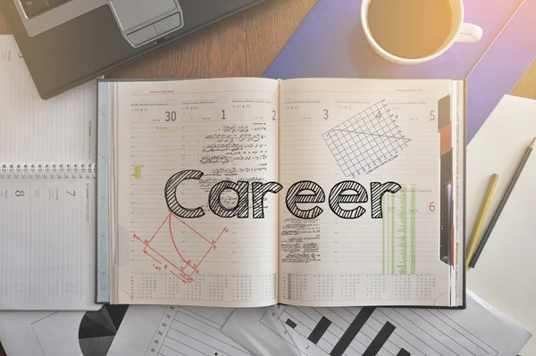 Notebook with text inside Career on table with coffee, some diagrams — Stock Photo, Image