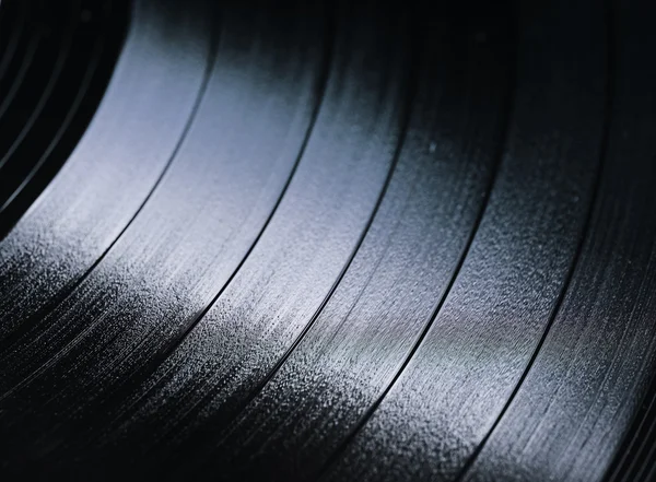 Segment of vinyl record with label showing the texture of the grooves — Stock Photo, Image