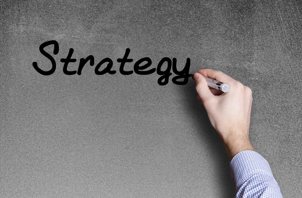 Mão escrever uma palavra de estratégia — Fotografia de Stock
