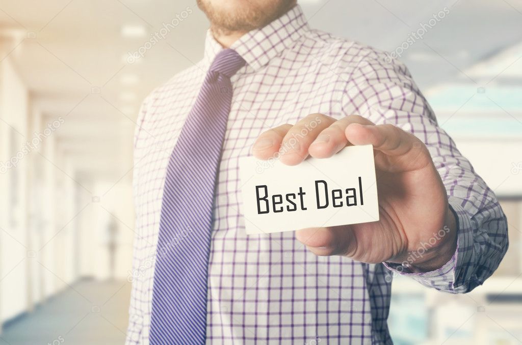 businessman in office showing card with text: Best Deal