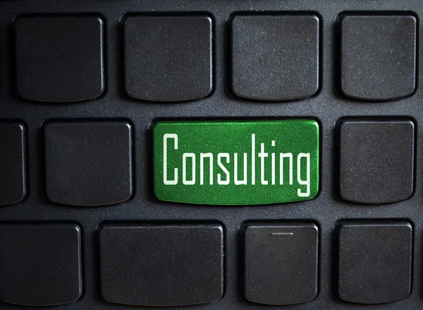 Green consulting button on black keyboard — Stock Photo, Image