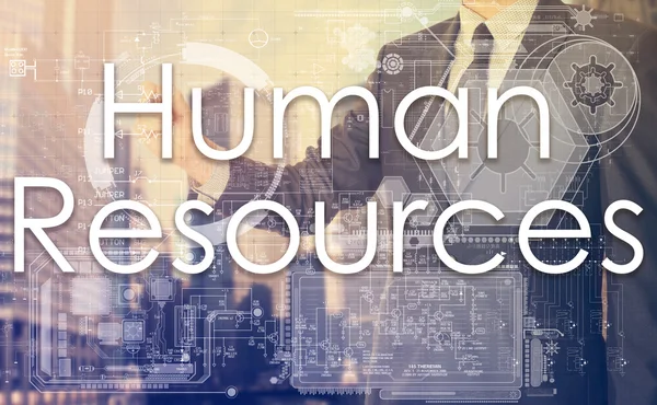 Businessman writes on board text: Human Resources - with sunset over the city — Stockfoto