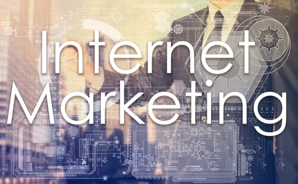 Businessman writes on board text: Internet Marketing - with sunset over the city — ストック写真