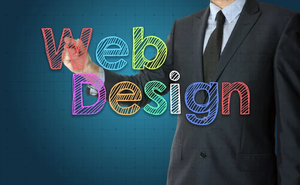 L'uomo d'affari sta scrivendo Web Design con carattere colorato sul bordo trasparente — Foto Stock