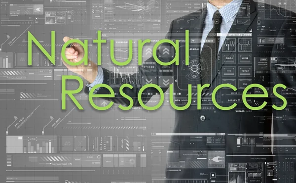 The businessman is writing Natural Resources on the transparent board — Stock Photo, Image