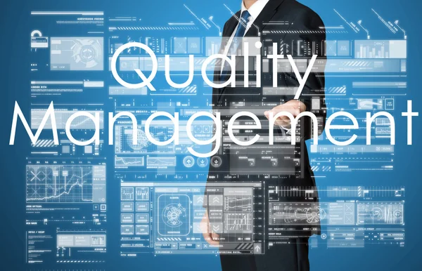 Uomo d'affari che presenta il testo della gestione della qualità e grafici e diagrammi — Foto Stock
