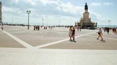 LISBON, takriben 2022 - Lizbon, Portekiz 'deki Ticaret Meydanı' nın hareketli bir tramvaydan görülen tanınmış Rua Augusta Kemeri 'nin yavaş çekim görüntüsü