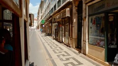 LISBON, 2022 dolaylarında Lizbon, Portekiz 'in merkezindeki Baixa semtinin pitoresk caddeleri boyunca Rossio Meydanı' na doğru ikonik tramvayla seyahat ediyor.