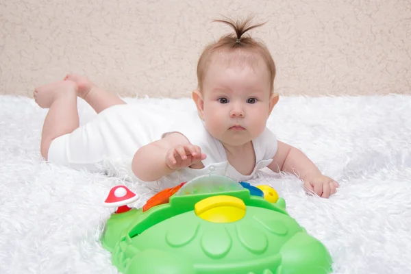 Little baby girl playing with a toy — Stock Photo, Image