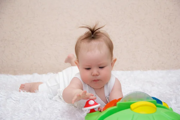 Little baby girl playing with a toy — Stock Photo, Image