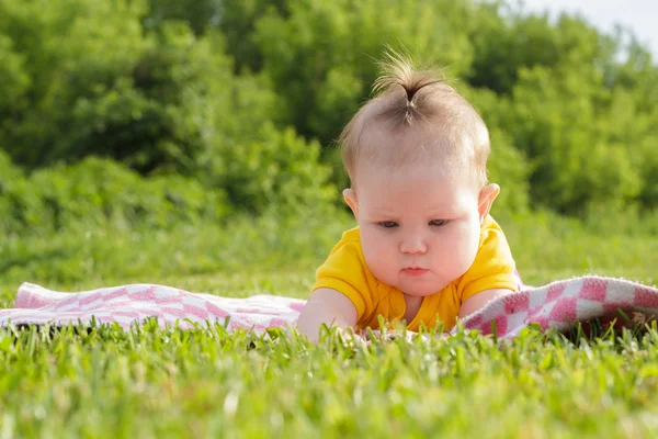 Kleines neugeborenes Mädchen liegt im Gras — Stockfoto