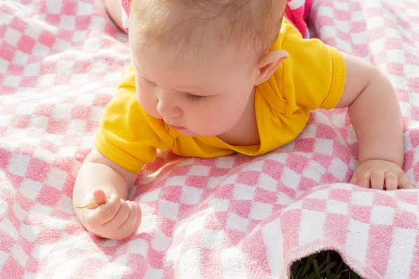 Pasgeboren meisje liggend op het gras — Stockfoto