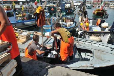 Camogli, Liguria, Italy - June 15, 2015 Fishermans with a catch  clipart