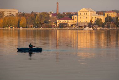 Ternopil şehrinin panoraması, kale, gölün manzarası balıkçı teknesiyle gün batımının altın saatlerinde