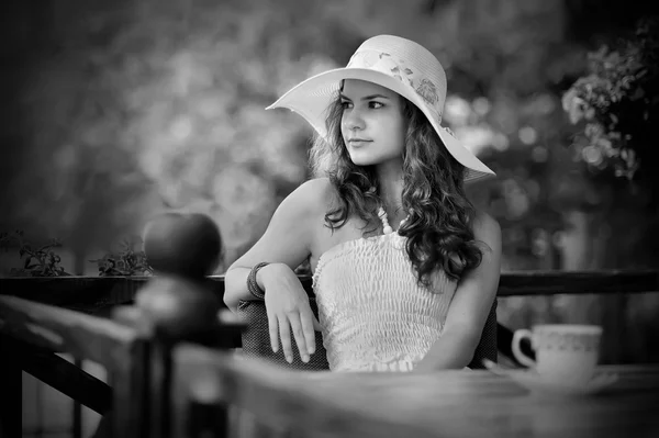 Romantic girl waiting on the terrace of summer cafe — Stock Photo, Image